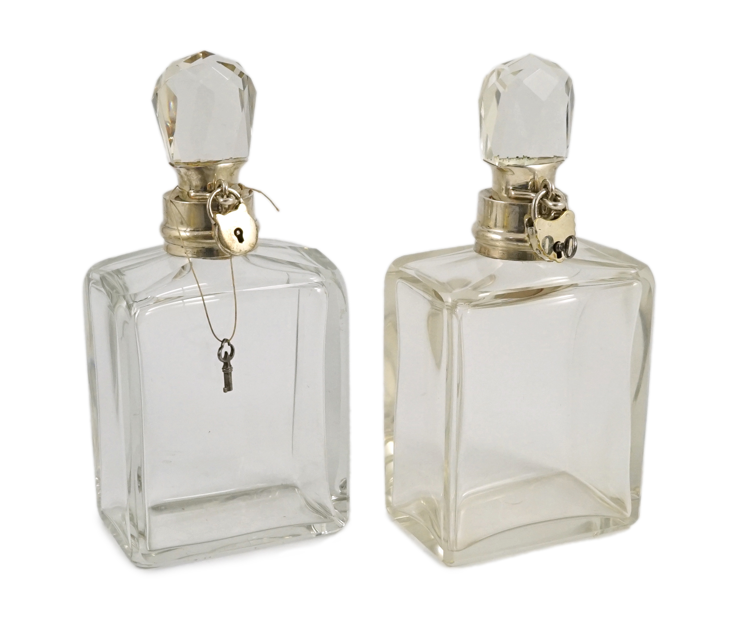 A pair of George V Hukin & Heath silver mounted glass lockable decanters and stoppers, with padlock and key